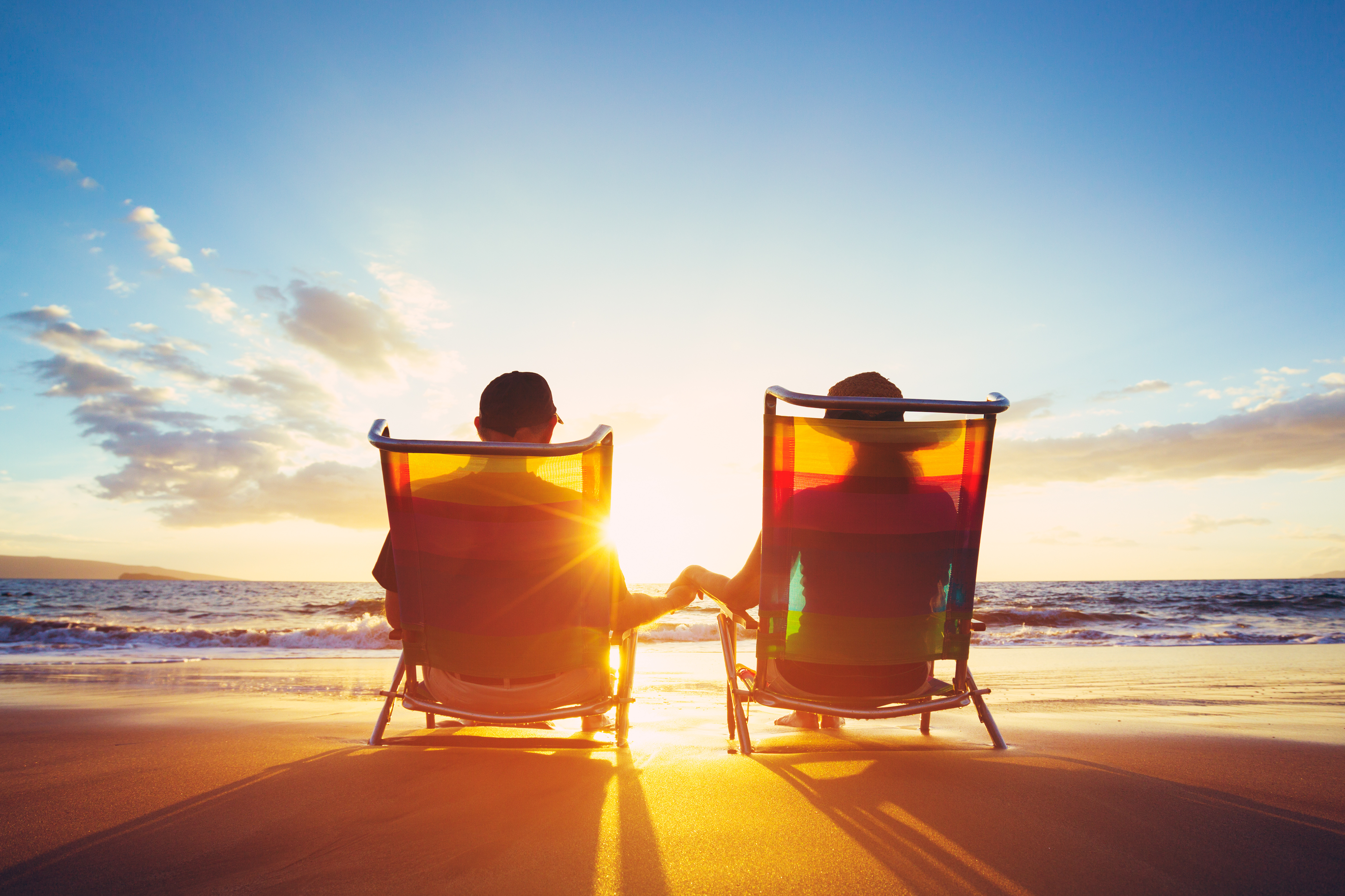Retirement Vacation Concept, Happy Mature Retired Couple Enjoying Beautiful Sunset at the Beach