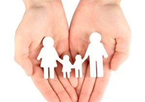 Female hands with paper family isolated on white